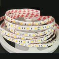 Close-up of a flexible 12V LED soft light strip with closely spaced white LEDs, showing solder connection patches.