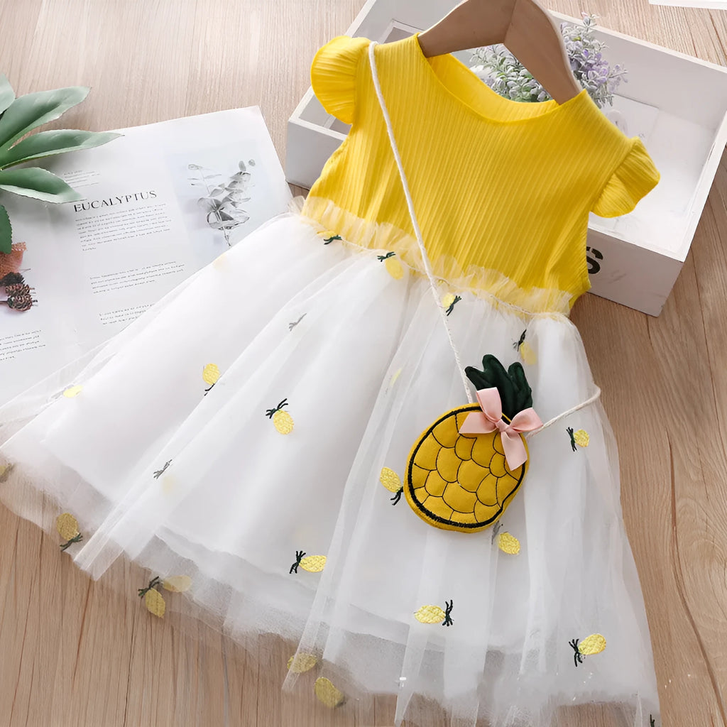 Girls summer cotton knit net yarn dress in yellow with optional coin purse, side view on child