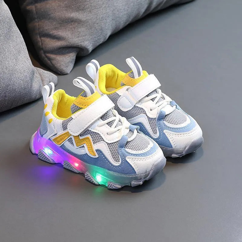 Children's light grey sneakers with mesh panels, Velcro strap, and a white rubber sole.