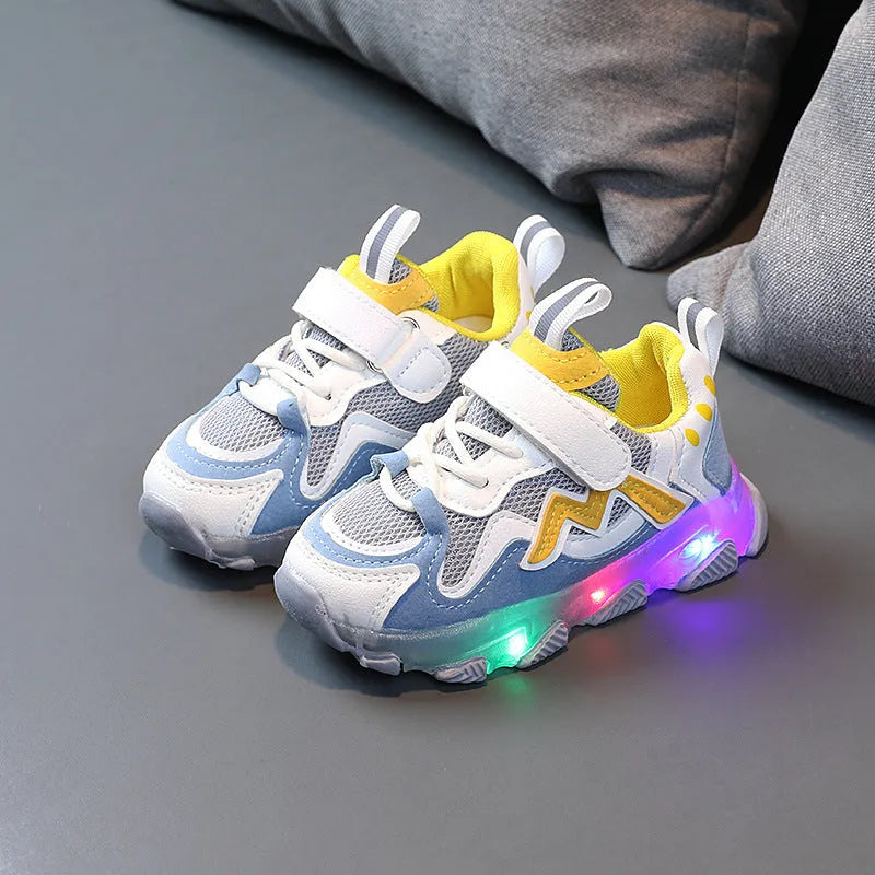 Children's light grey sneakers with mesh panels, Velcro strap, and a white rubber sole.