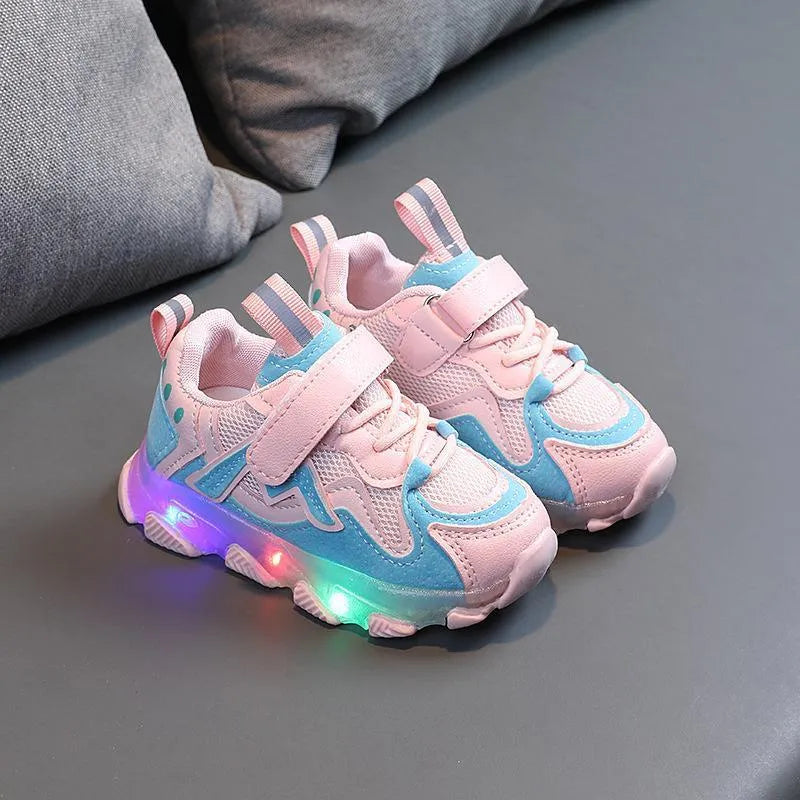 Children's light grey sneakers with mesh panels, Velcro strap, and a white rubber sole.
