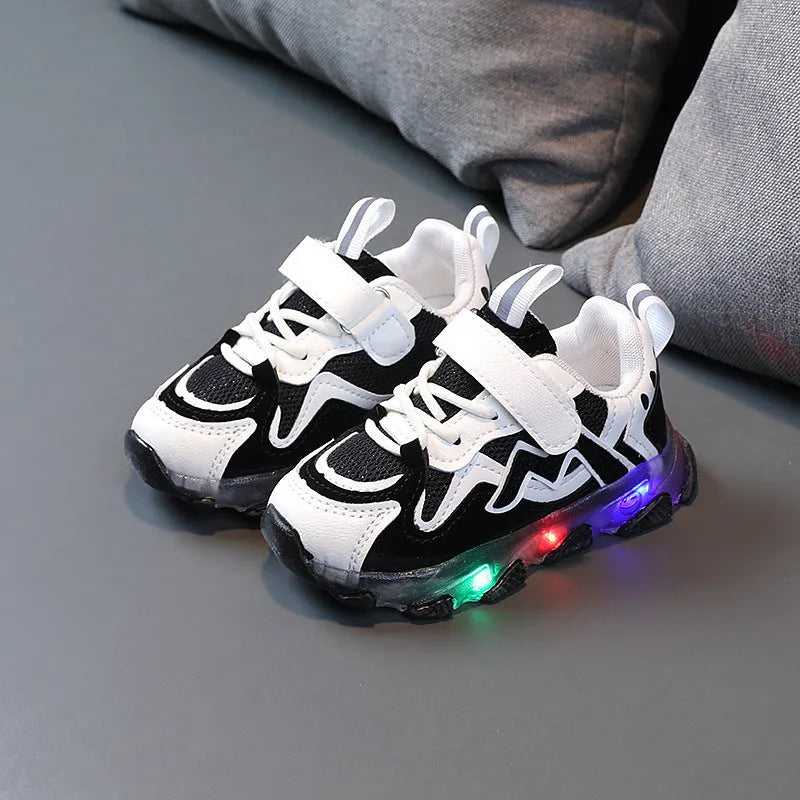 Children's light grey sneakers with mesh panels, Velcro strap, and a white rubber sole.