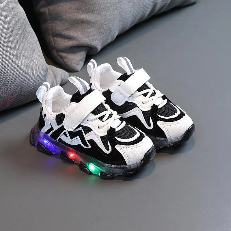 Children's light grey sneakers with mesh panels, Velcro strap, and a white rubber sole.