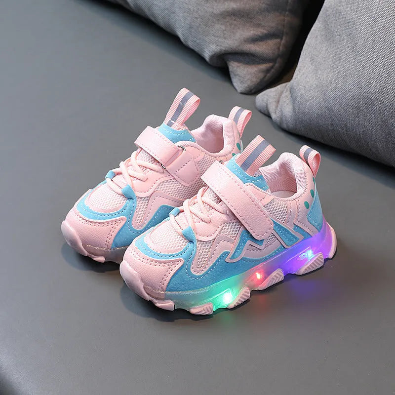 Children's light grey sneakers with mesh panels, Velcro strap, and a white rubber sole.