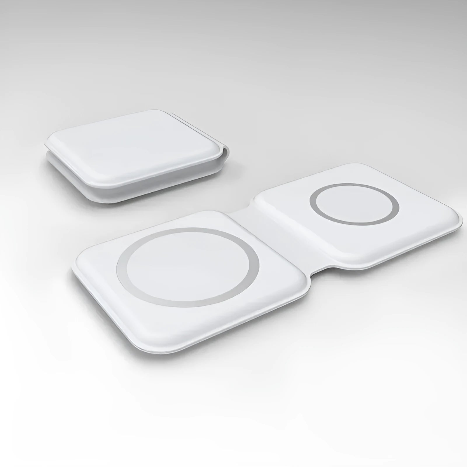 White foldable magnetic wireless charger charging two phones simultaneously on angled stand