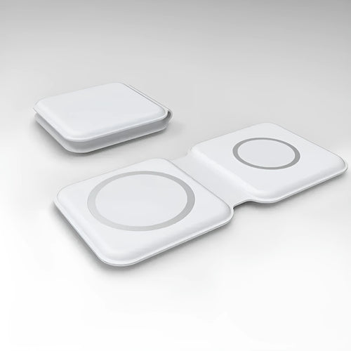 White foldable magnetic wireless charger charging two phones simultaneously on angled stand