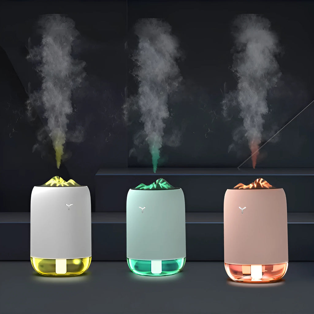 Mini columnar ultrasonic humidifier with magic flame light effect in white, blue, and pink colour options.