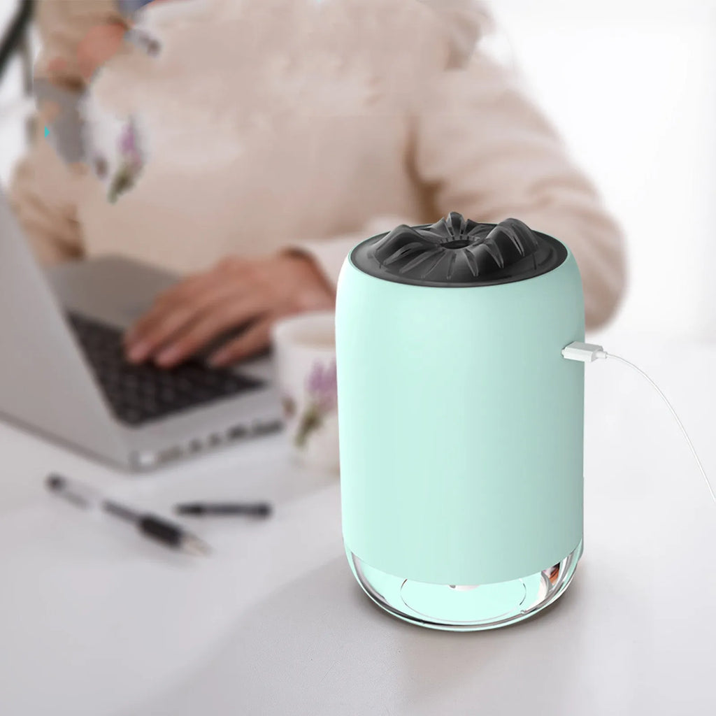 Mini columnar ultrasonic humidifier with magic flame light effect in white, blue, and pink colour options.