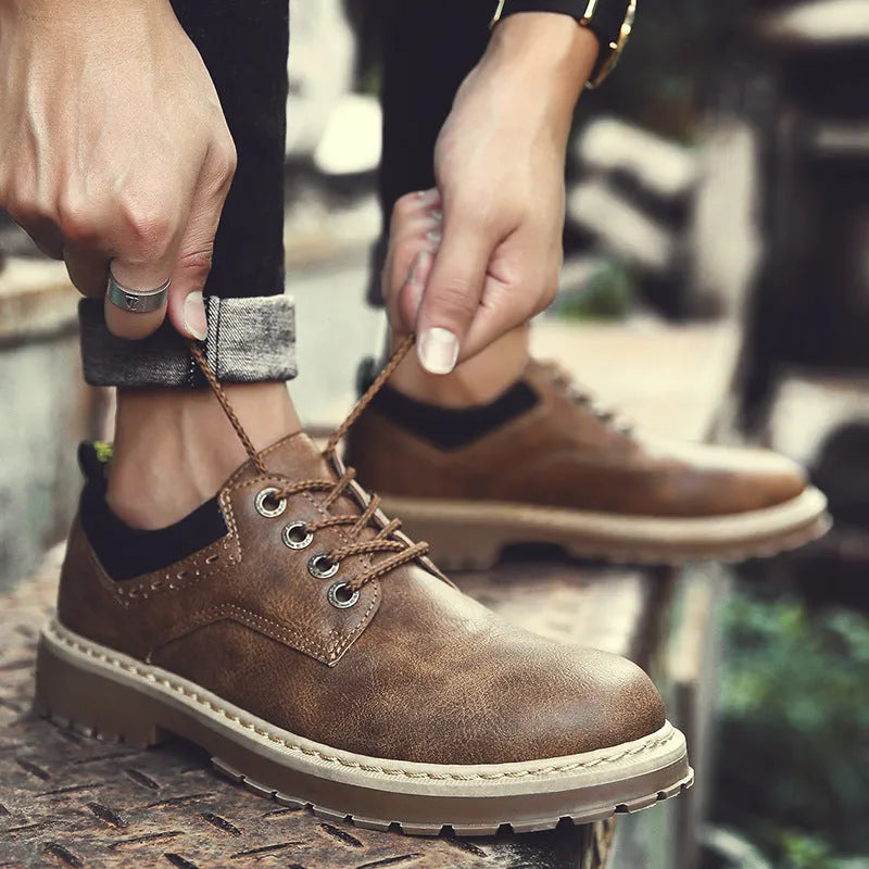 Men's black casual shoes with round toe and rubber soles showing front-tie design