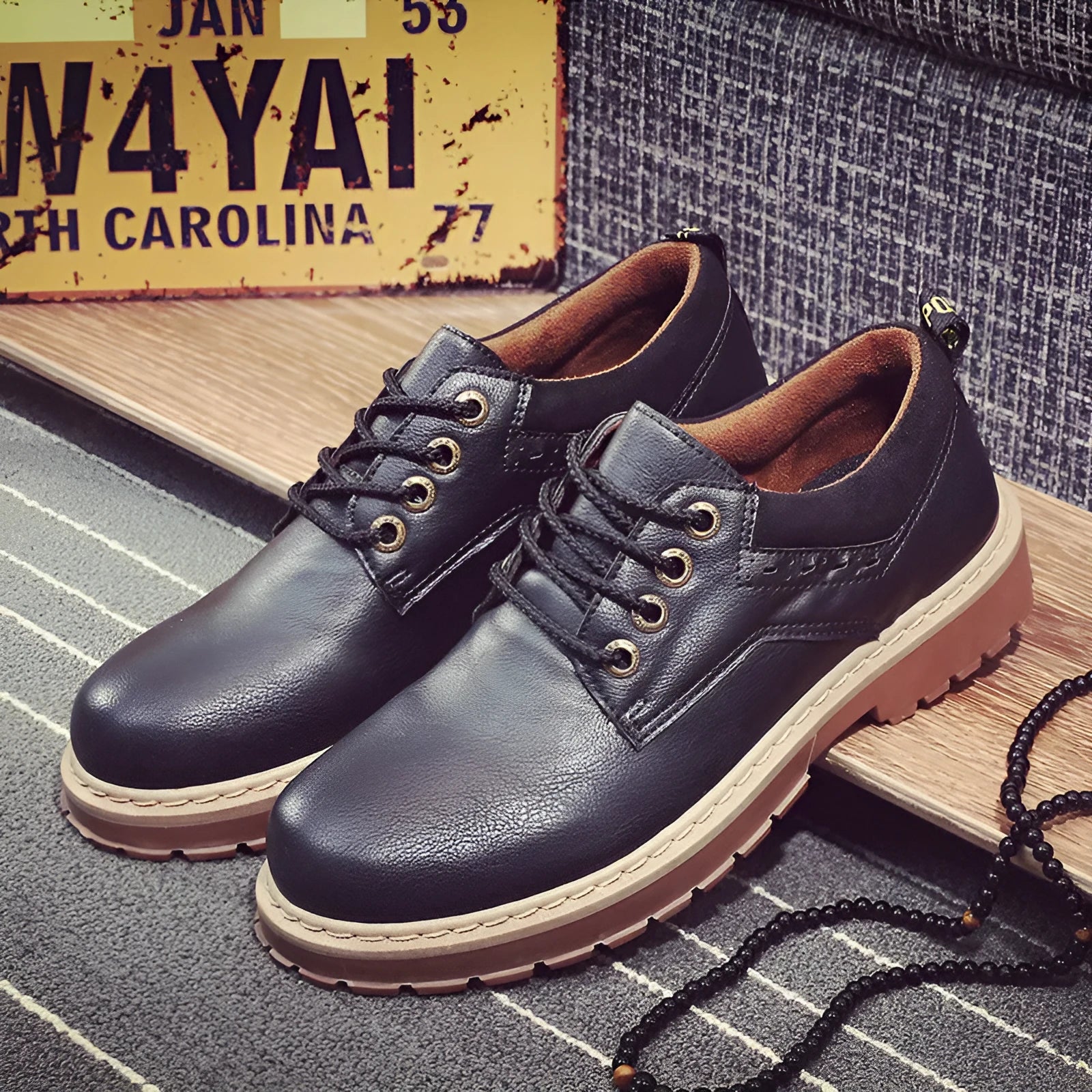 Men's black casual shoes with round toe and rubber soles showing front-tie design
