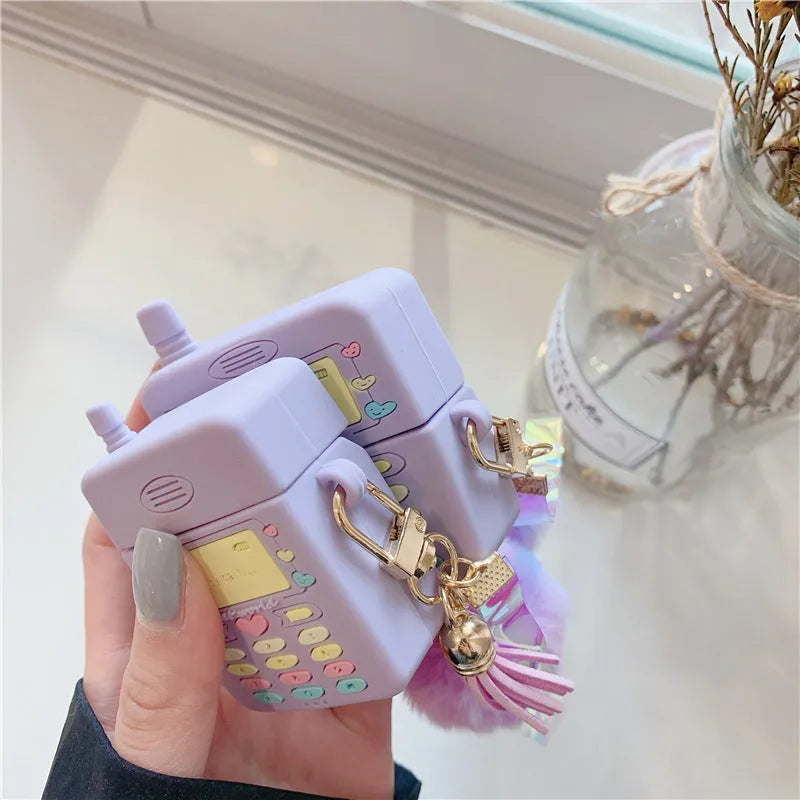 Purple silicone clamshell AirPods case with fur ball pendant for Apple wireless headphones