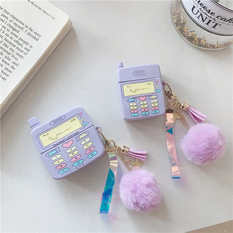 Purple silicone clamshell AirPods case with fur ball pendant for Apple wireless headphones
