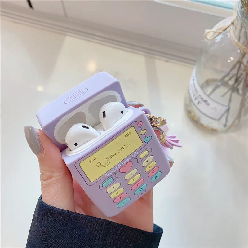 Purple silicone clamshell AirPods case with fur ball pendant for Apple wireless headphones