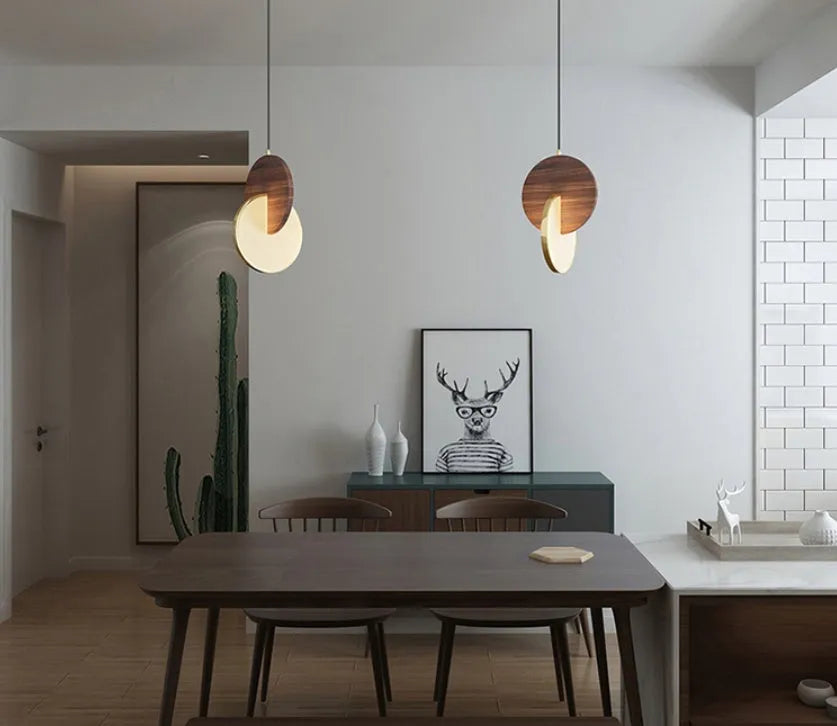 Long-line carved walnut wood wall chandelier emitting warm white light in a modern room setting.