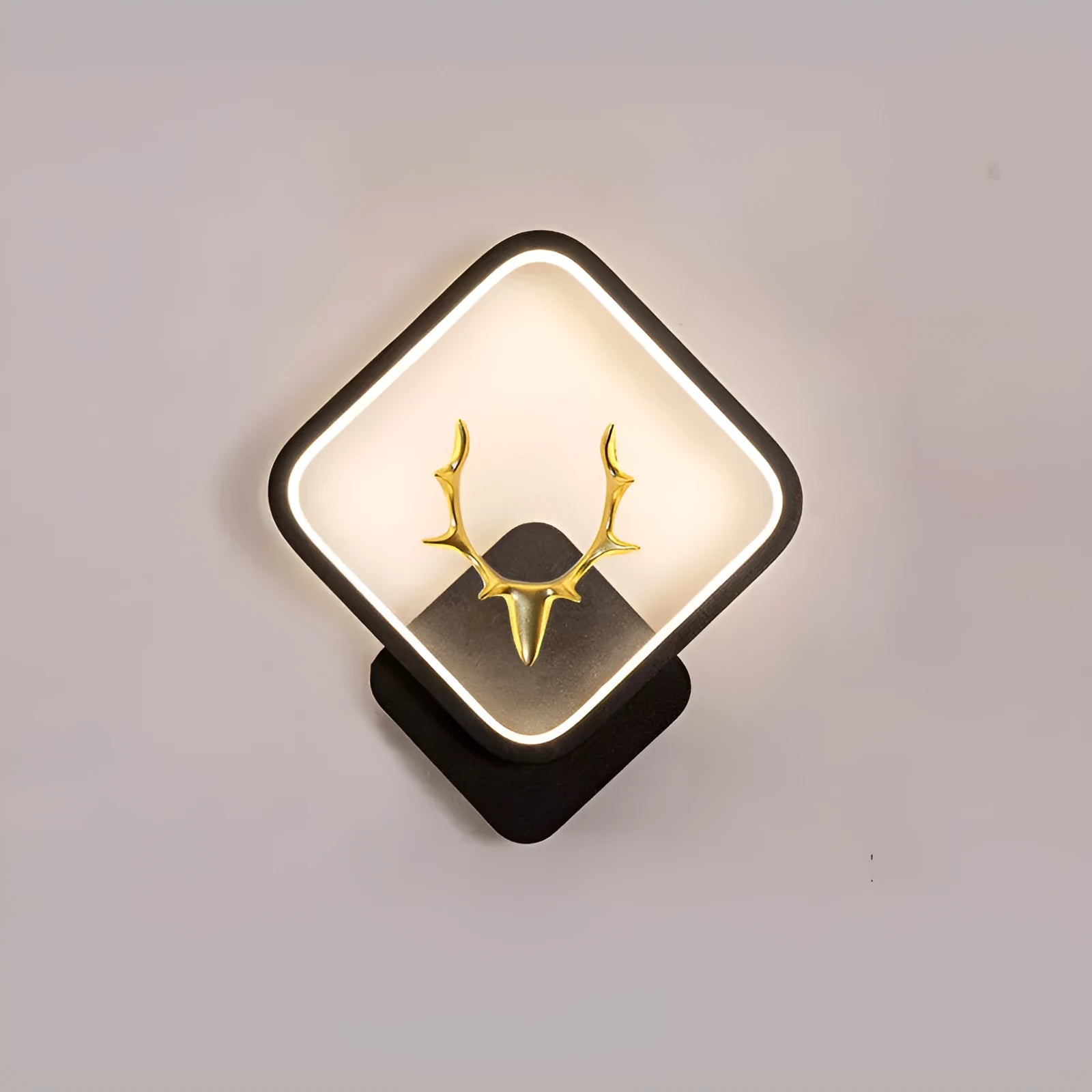 Deer antler shaped wall lamp with remote control on a white wall, showing Nordic design.