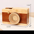 Wooden camera-shaped music box with rotating mechanism on pine wood base