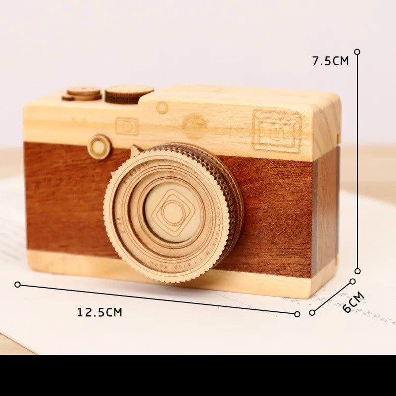 Wooden camera-shaped music box with rotating mechanism on pine wood base