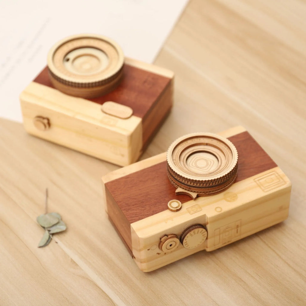 Wooden camera-shaped music box with rotating mechanism on pine wood base