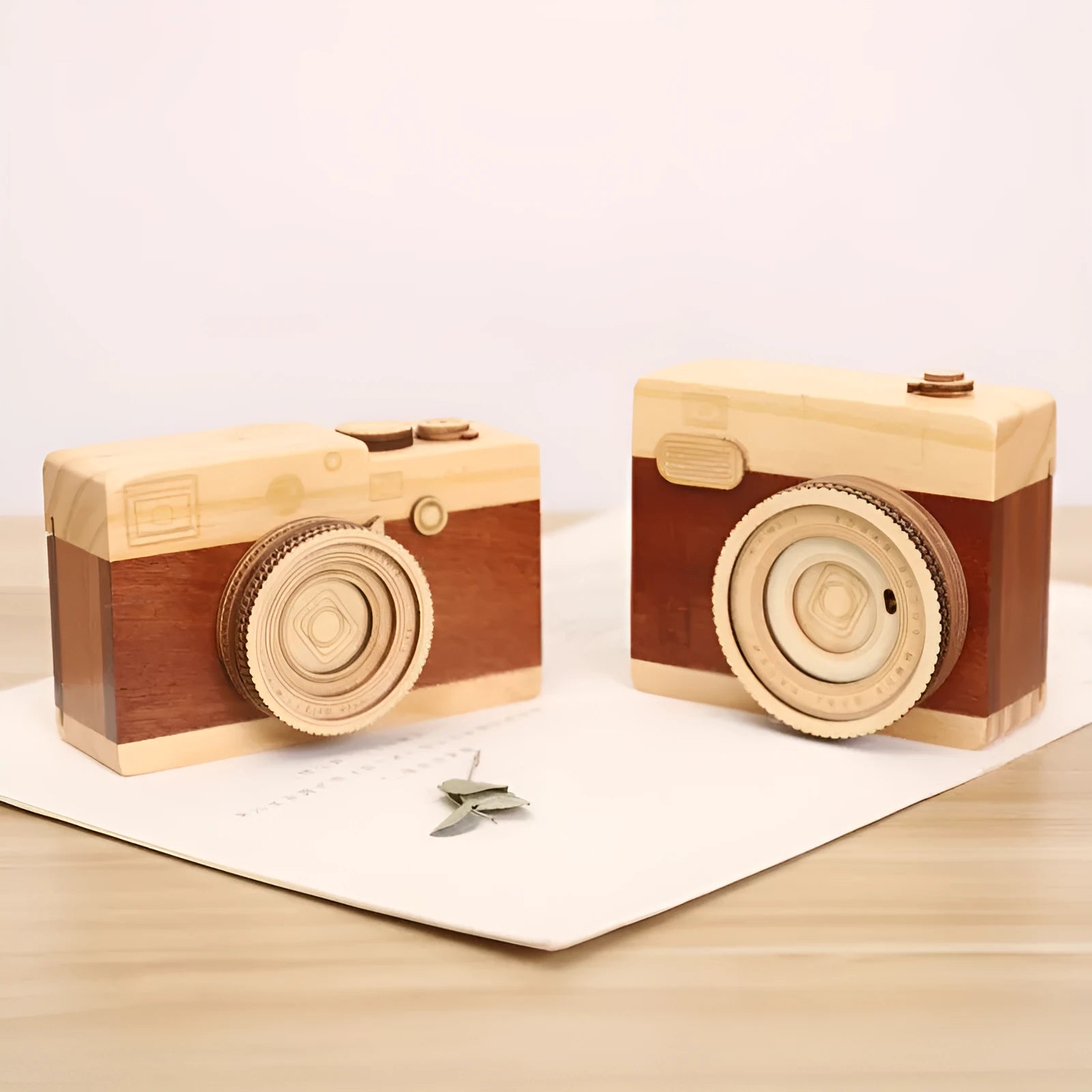 Wooden camera-shaped music box with rotating mechanism on pine wood base