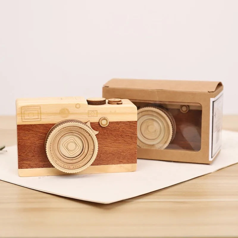Wooden camera-shaped music box with rotating mechanism on pine wood base