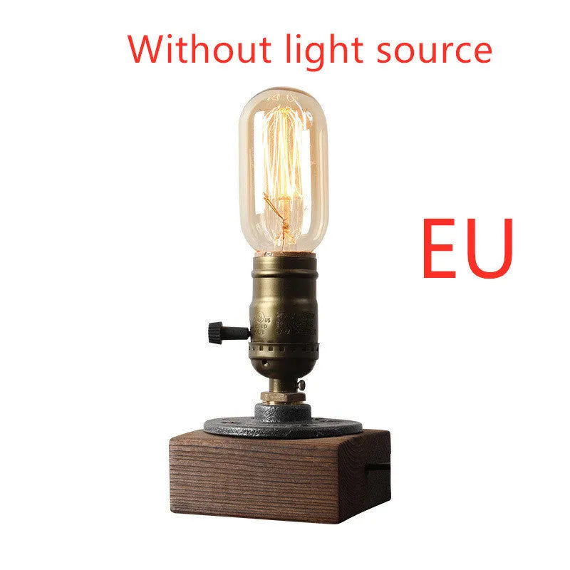 Industrial-style wooden and iron water pipe table lamp on a surface, showing its compact size.