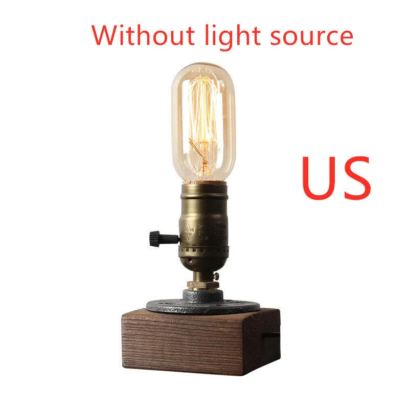 Industrial-style wooden and iron water pipe table lamp on a surface, showing its compact size.