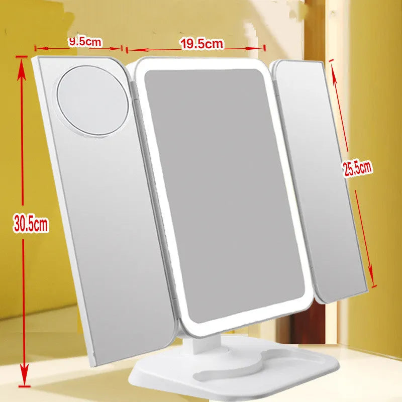 Trifold LED makeup mirror with 68 lights, 10X magnifying mirror, and USB rechargeable battery on table