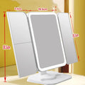 Trifold LED makeup mirror with 68 lights, 10X magnifying mirror, and USB rechargeable battery on table