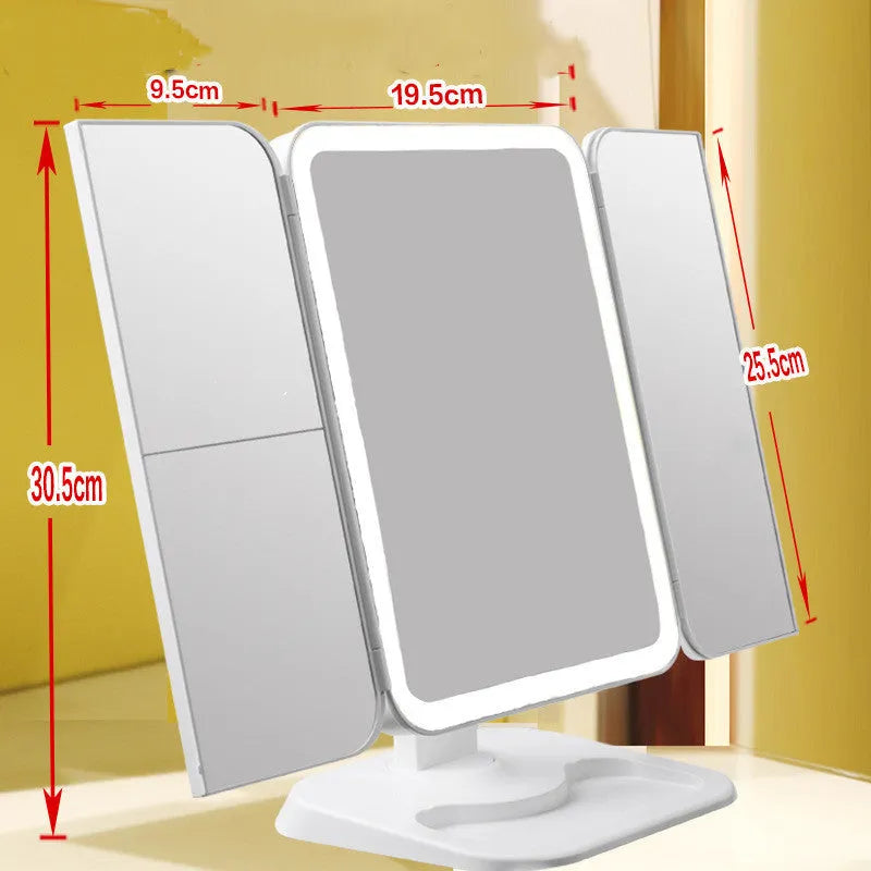 Trifold LED makeup mirror with 68 lights, 10X magnifying mirror, and USB rechargeable battery on table