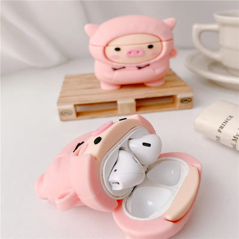 Pink silicone AirPods case with cartoon pig design, flip opening, and hook attachment