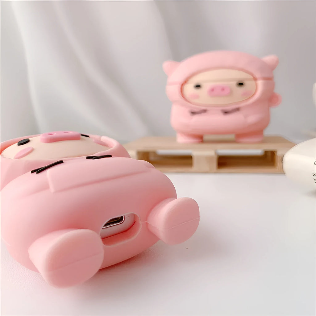 Pink silicone AirPods case with cartoon pig design, flip opening, and hook attachment