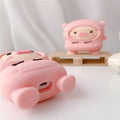 Pink silicone AirPods case with cartoon pig design, flip opening, and hook attachment
