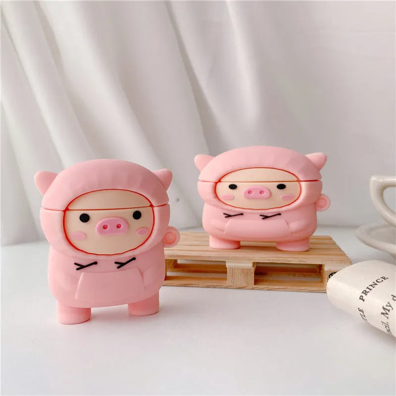 Pink silicone AirPods case with cartoon pig design, flip opening, and hook attachment