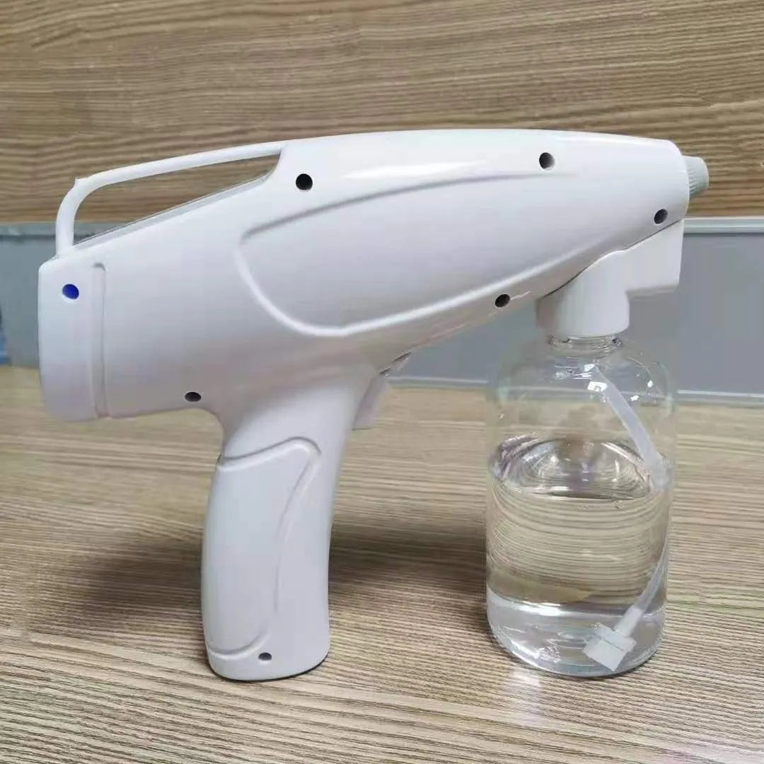 White handheld cordless electric spray disinfection gun with USB charging cable