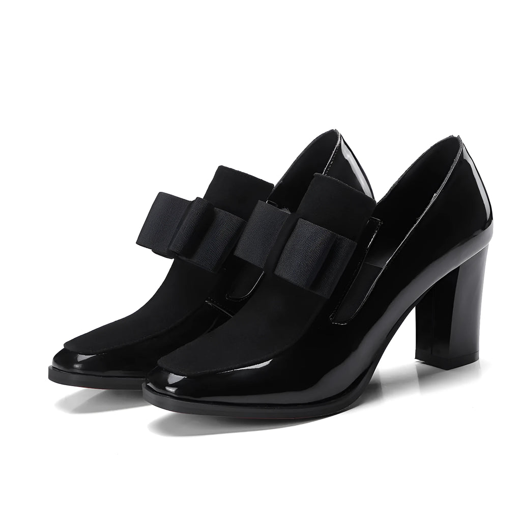 Black patent leather women's high heels with a thick square heel and rubber sole.