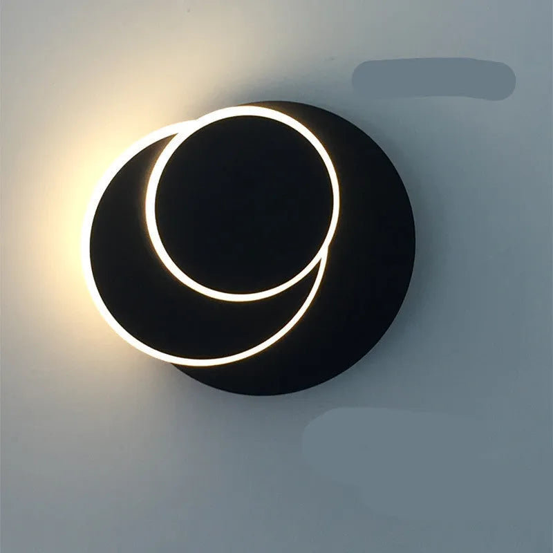 Modern round acrylic wall lamp in black or white, shown in small, medium, and large size options.