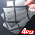 Four transparent tempered glass screen protectors for iPhone models on a clean surface.