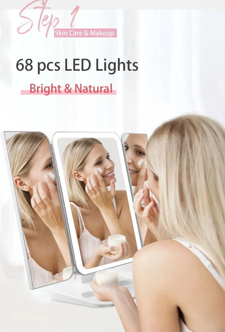 Trifold LED makeup mirror with 68 lights, 10X magnifying mirror, and USB rechargeable battery on table