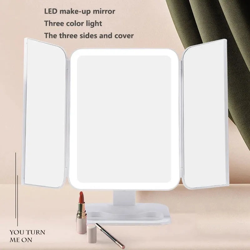 Trifold LED makeup mirror with 68 lights, 10X magnifying mirror, and USB rechargeable battery on table