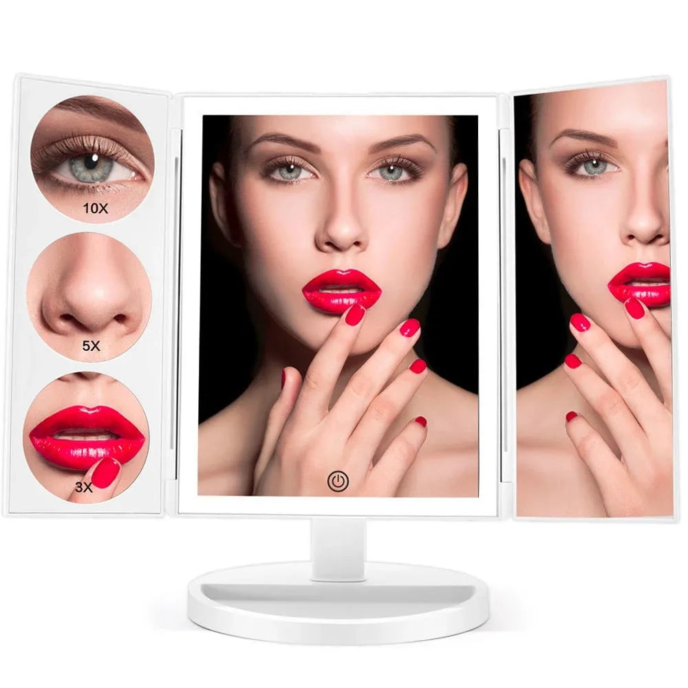 Trifold LED makeup mirror with 68 lights, 10X magnifying mirror, and USB rechargeable battery on table