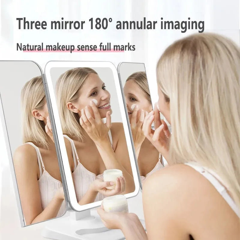 Trifold LED makeup mirror with 68 lights, 10X magnifying mirror, and USB rechargeable battery on table
