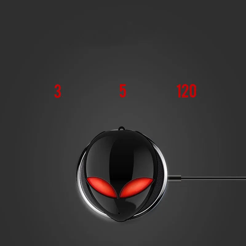 Creative Outer T8 Starman alien-design Bluetooth earbuds with red lighting next to wireless charging case.