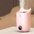White double spray humidifier with USB cable and three mist outlets on a wooden table.
