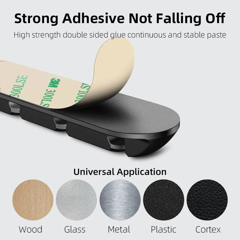 Black soft plastic magnetic cable organiser for desktop charging cable storage.