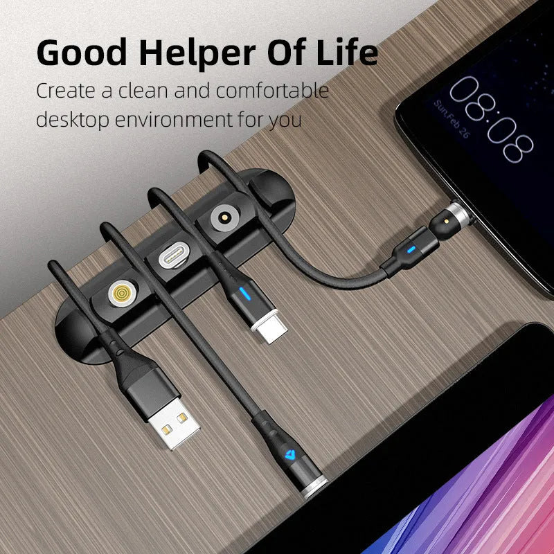 Black soft plastic magnetic cable organiser for desktop charging cable storage.