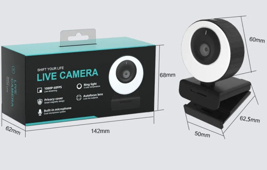 Black USB webcam with a magnetic privacy cover on a desk next to a laptop.