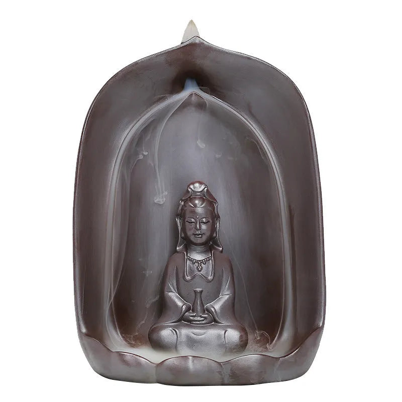 Ceramic Guanyin sitting lotus back flow incense burner with smoke cascading downward on home altar