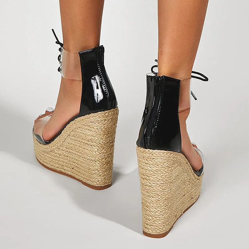Black women's wedge sandals with hemp rope detail, super high wedge heel, and front tie closure.
