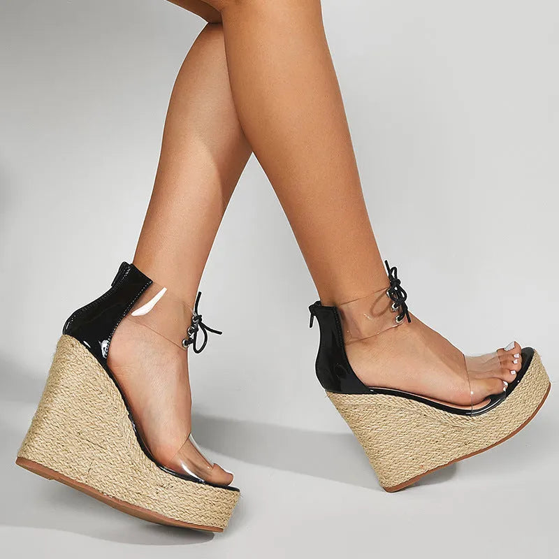 Black women's wedge sandals with hemp rope detail, super high wedge heel, and front tie closure.