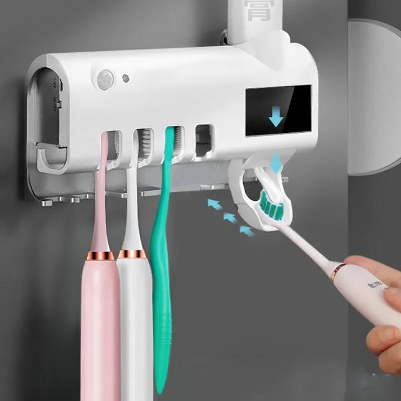 Black smart UV toothbrush steriliser and automatic toothpaste squeezer mounted on a bathroom wall.